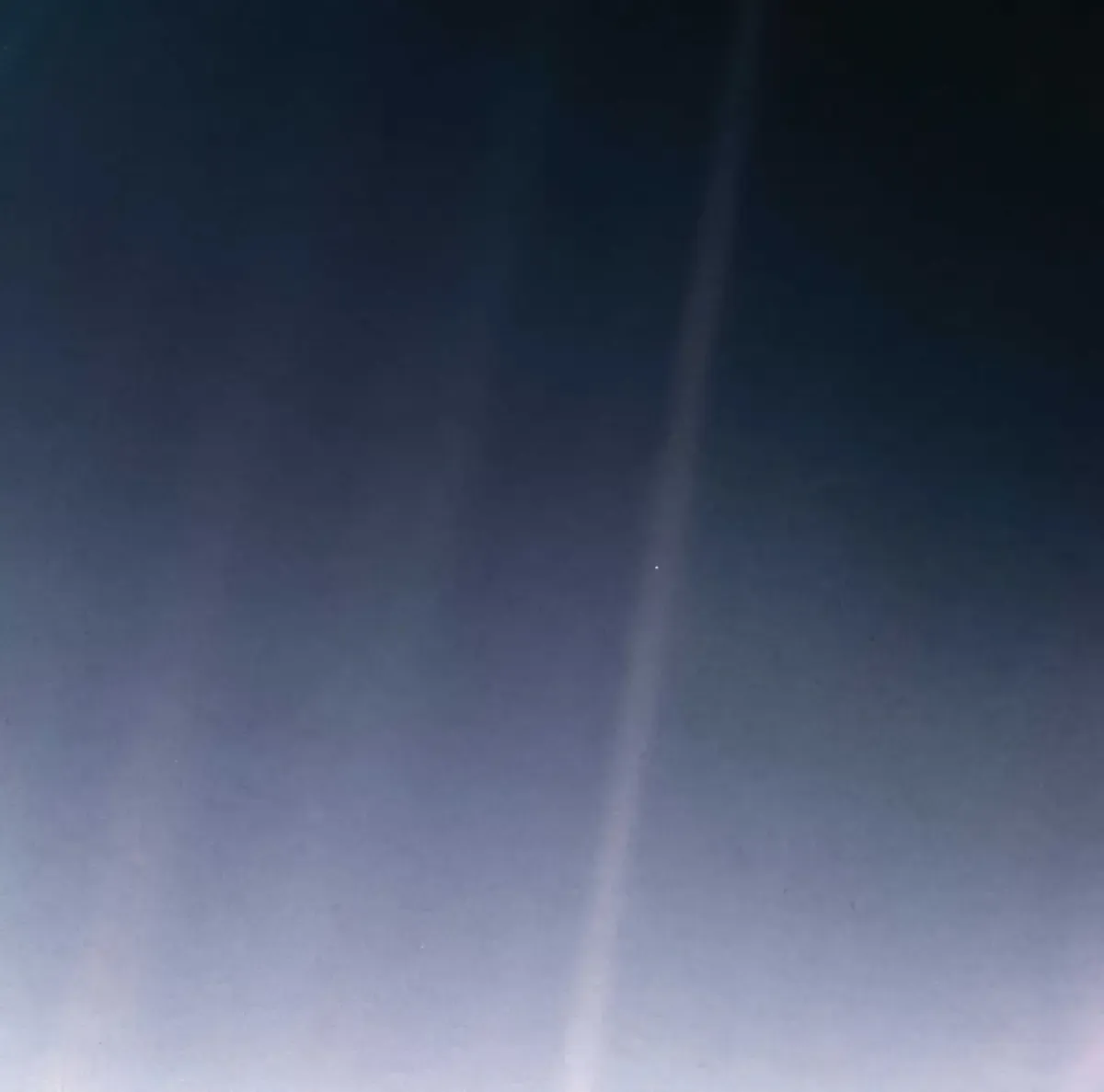 The original &lsquo;Pale Blue Dot&rsquo; photograph taken by Voyager 1 in 1990, showing Earth as a tiny speck in a sunbeam.